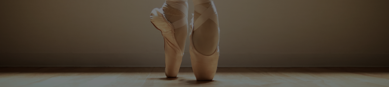 Ballerina Wearing Pointe Shoes on Tip Toes.png