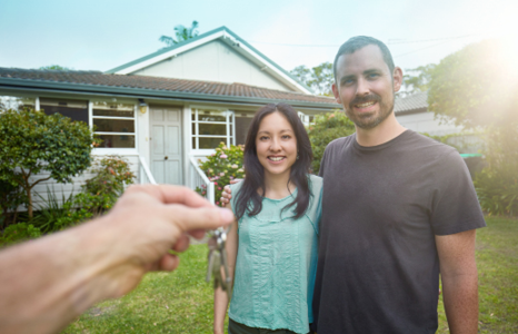 Couple Being Handed Keys to New Home.png