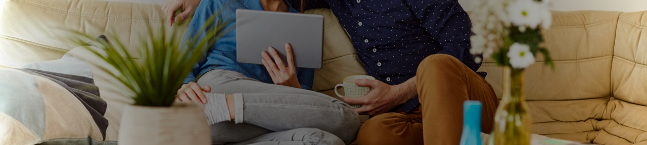 Couple Browsing Interest Rates on Tablet Together on Couch.png