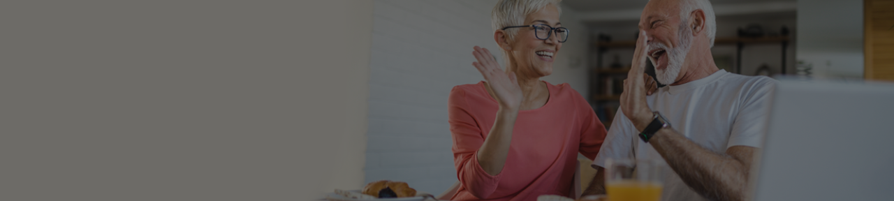 Couple High Fiving in Celebration of Investment Savings