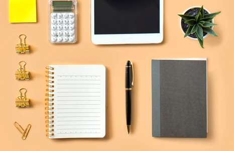 Desk with Office Supplies, Tablet and Plant.png