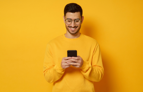 Man in Yellow Sweater Switching with ClickSWITCH on Mobile Phone
