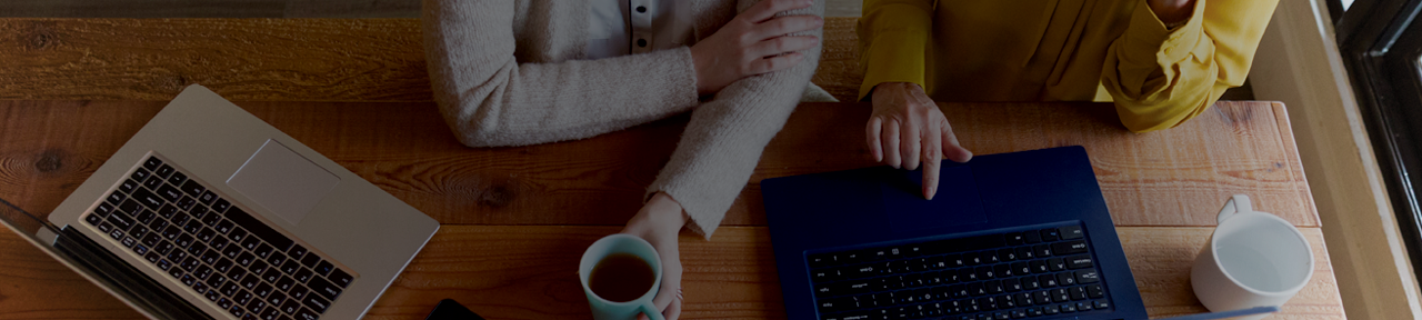 People Collaborating on Laptops with Coffee