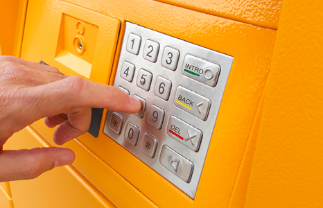 Person Typing on Number Pad at ATM