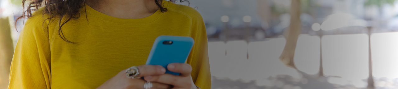 Woman Texting on Mobile Phone with Neon Blue Case Outside