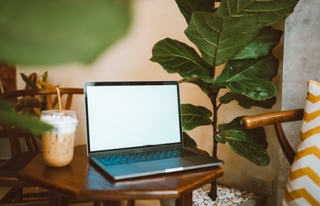 Wooden Table with Laptop and Iced Coffee