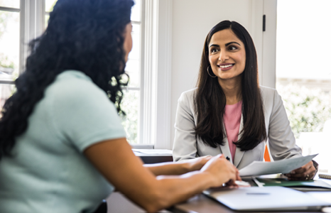 Two People Discussing Foreign Exchange Options at a Desk