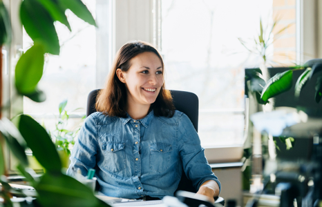 Person Sitting at a Desk Smiling 