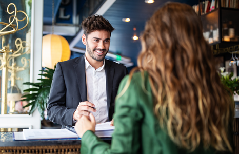 Two People Standing at Concierge Desk