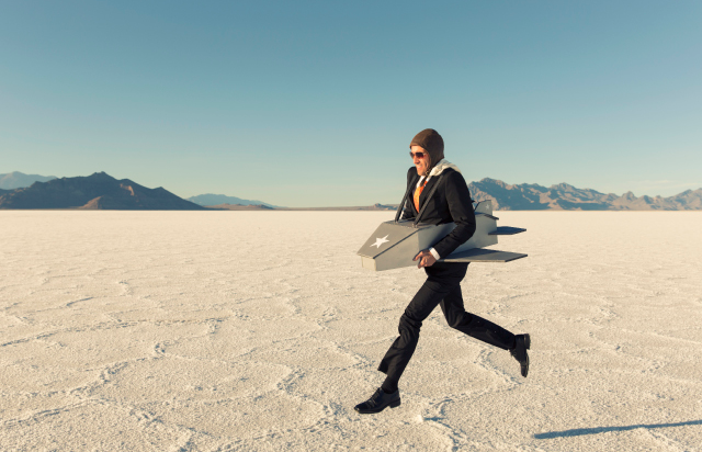 Man in Aitplane Costume Running Through Desert