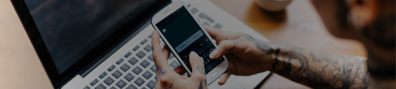 Person Using Mobile Phone and Laptop for Banking