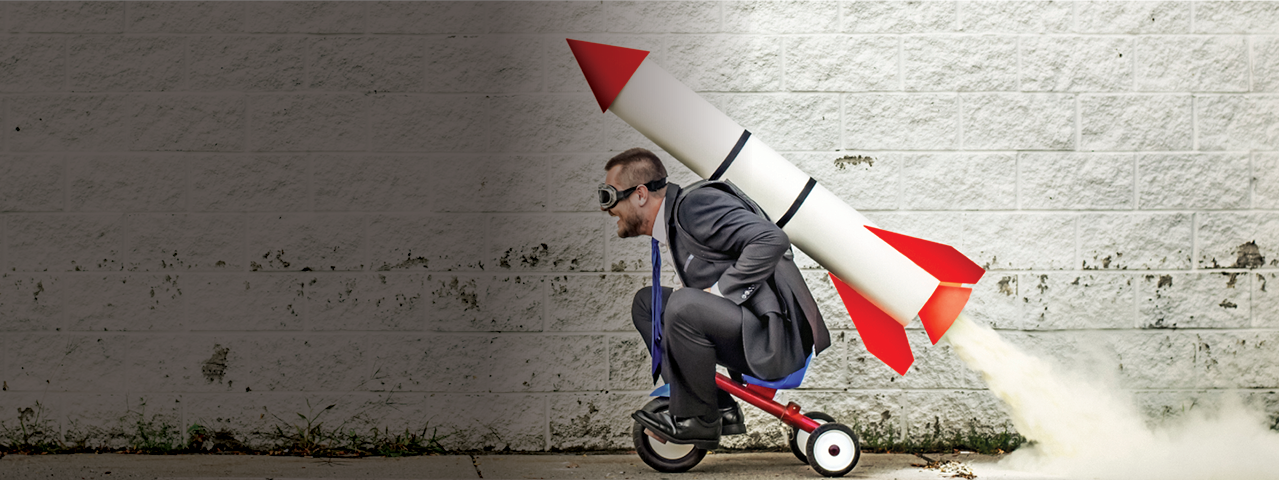 Person on Tricycle with Rocket on Back