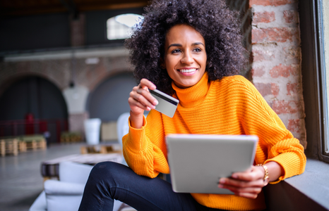 Woman Holding Credit Card and Tablet