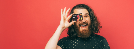 Man Smiling While Holding FirstOntario Debit Mastercard
