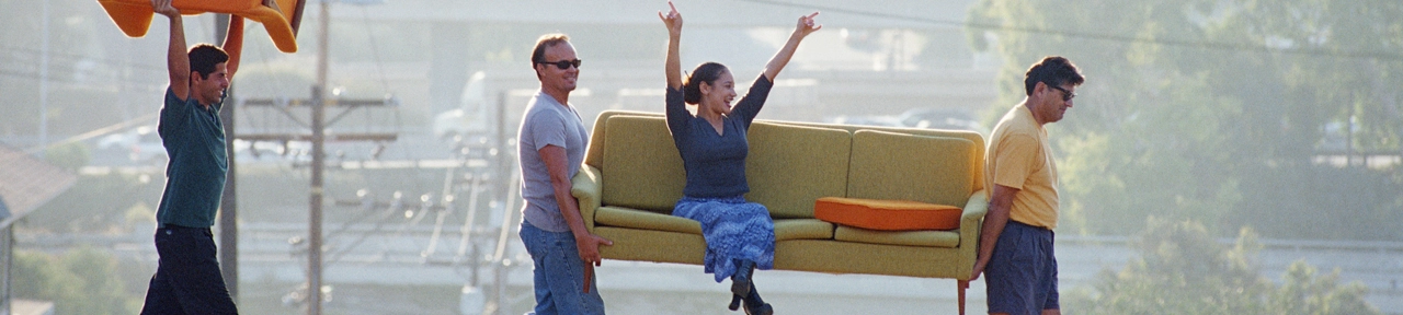 Group of Friends Carrying Couch Across the Street