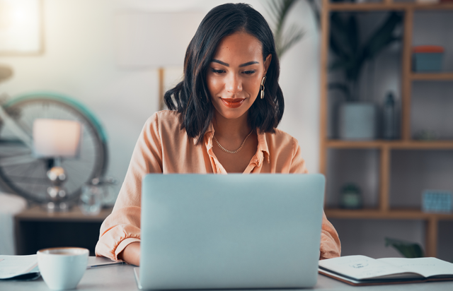 Woman Using Laptop to Browse RRSP-eligible Term Deposits